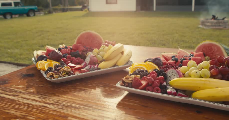 Fruit filled trays sit on wooden table
