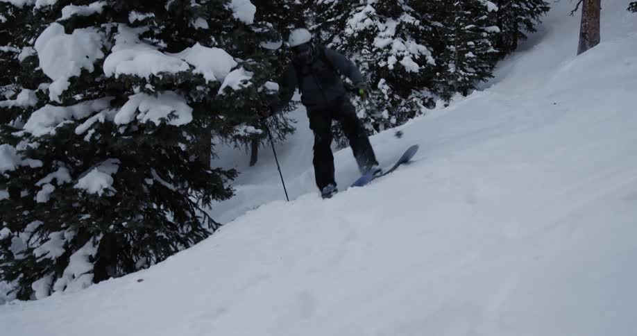 Man with helmet jacket and pants skier down mountain slope