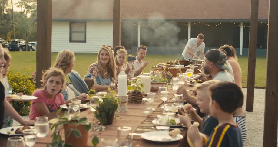 A group of people eating at a large table outdoors