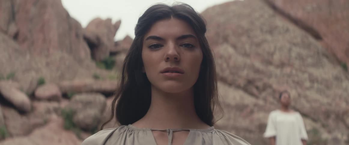 A woman is standing by the canyon