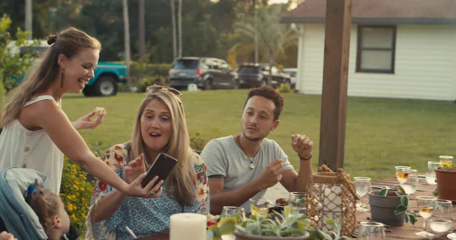 People are talking and eating in their yard