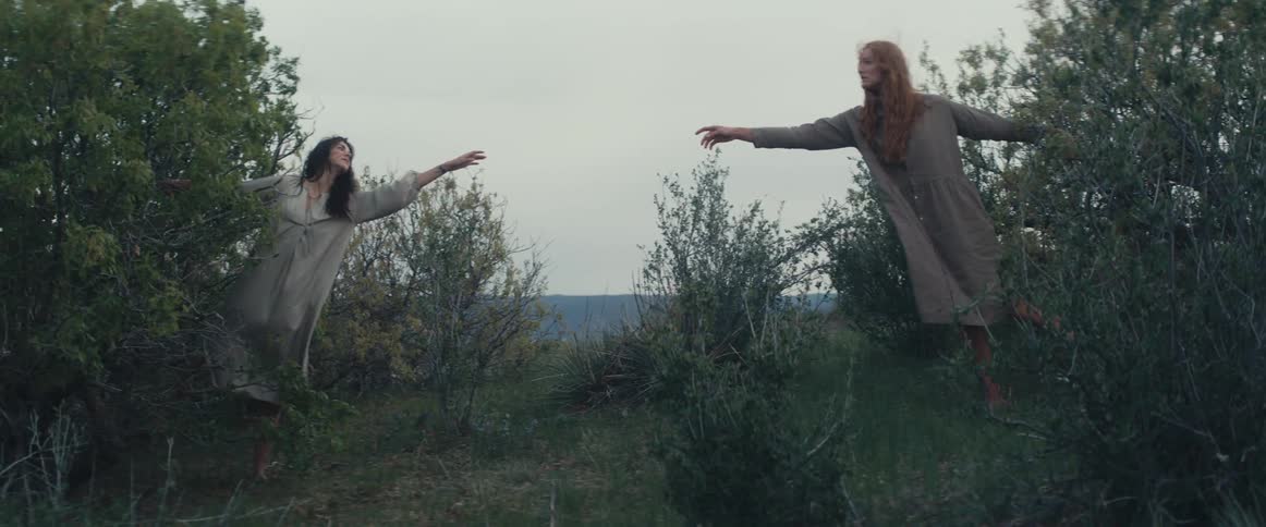 Two women are standing outdoors in spring
