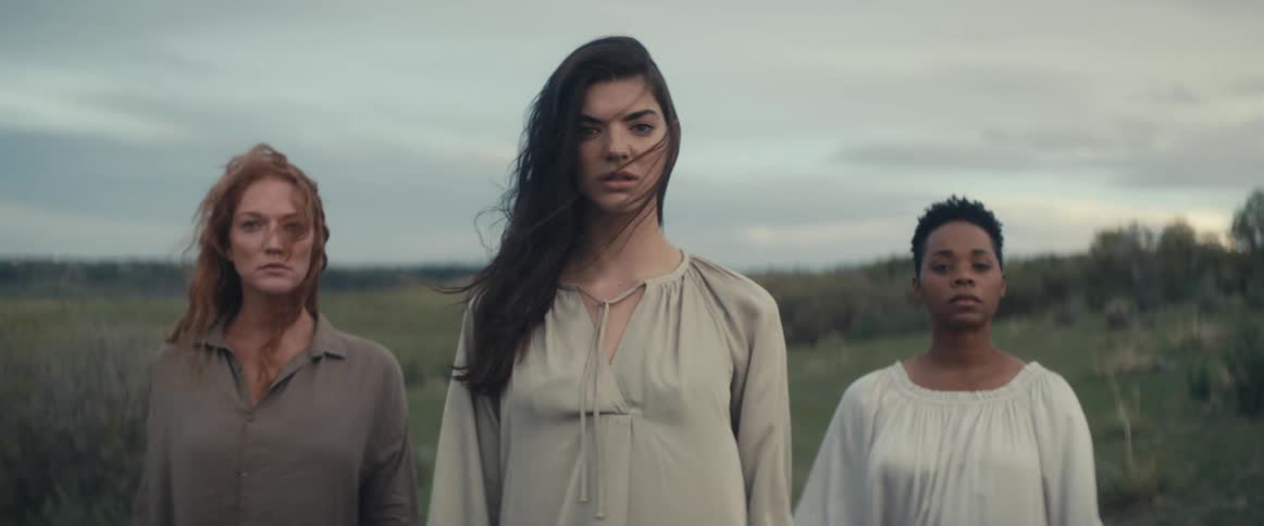 A portrait of three women outdoors