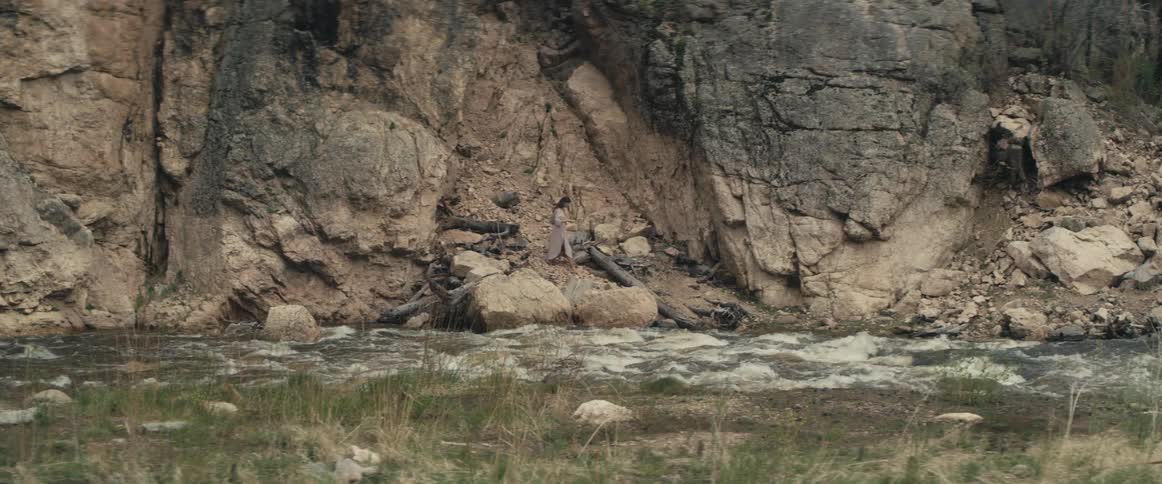 A view of a river flowing near rocks