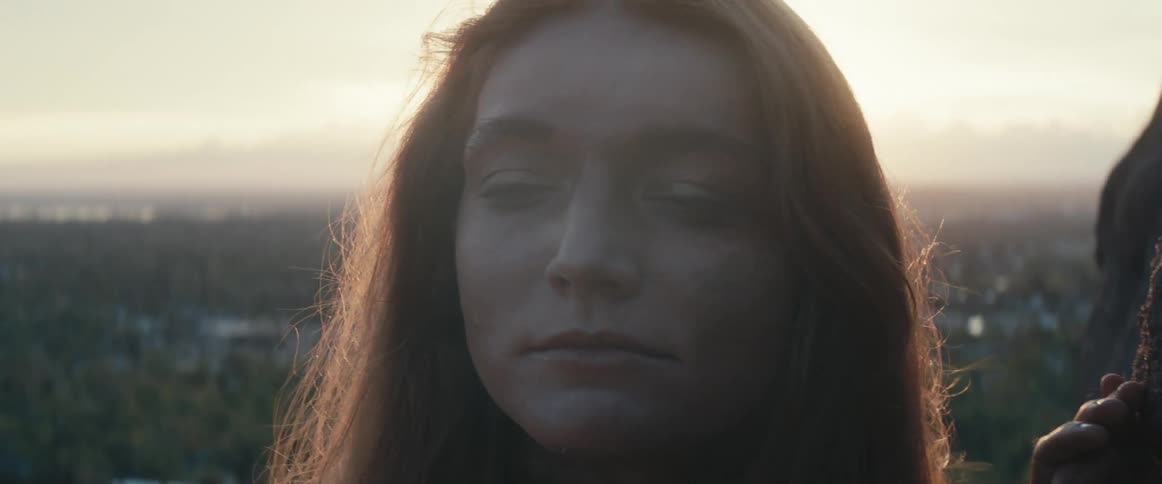 A portrait of a woman standing outdoors