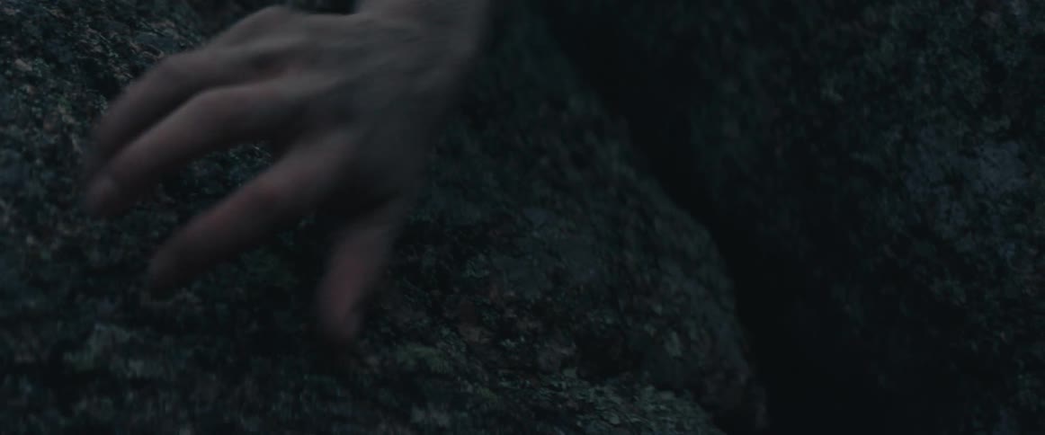 Womans dirty hand touches rock