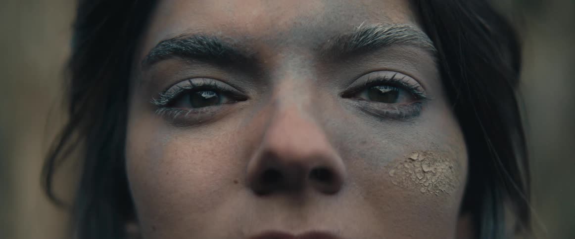 Close up of a teenage girls face that is crusted with dirt