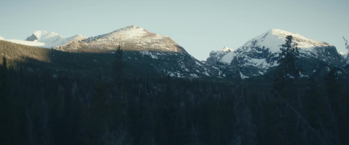 A view of mountains with snow on them