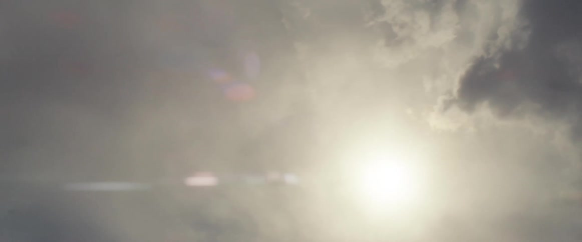 The sun is shining through the clouds