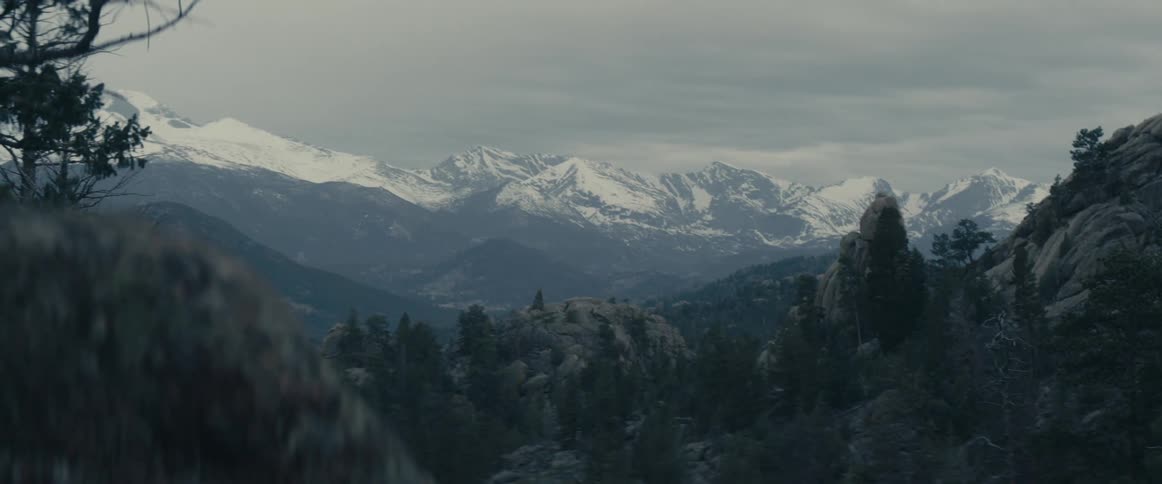 Panoramic view of clouds over snow capped mountains