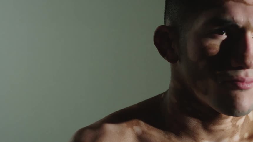 A man is standing in an empty room