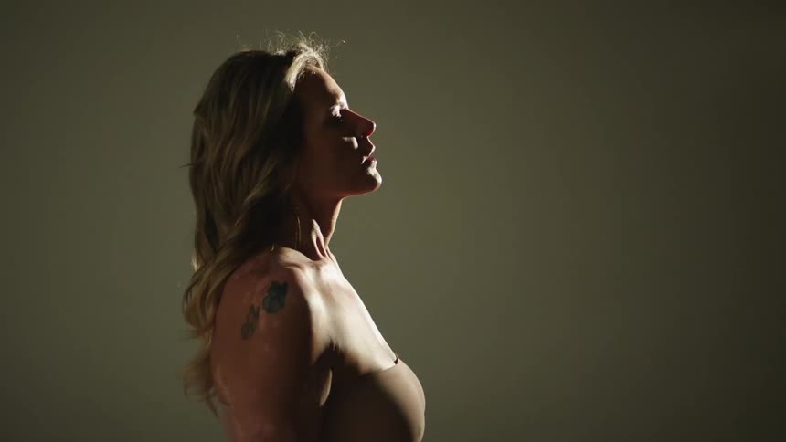 A profile view of a woman in a photography studio with flashing lights