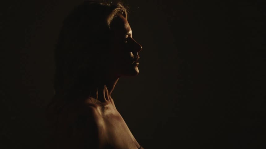 A woman is standing in a room with flashing lights