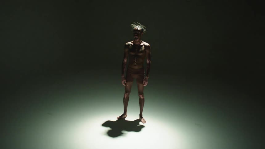 A portrait of a man standing in a studio