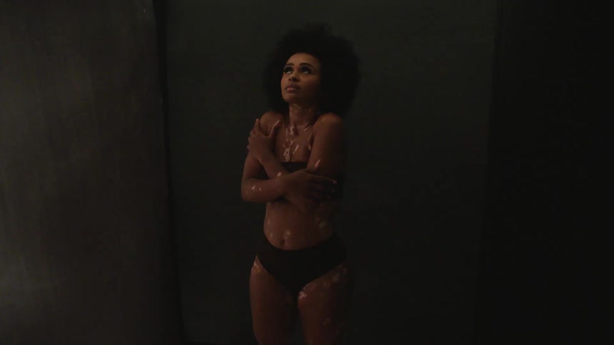 A woman rubs her arms in the dark room