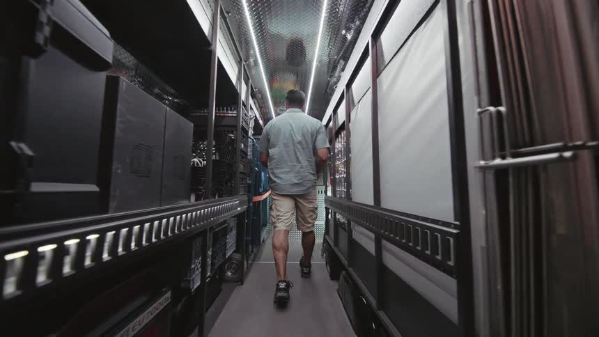 A man enters the truck full of equipment