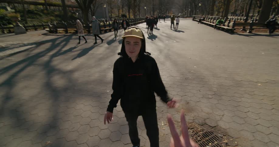 Two friends greet each other in the park