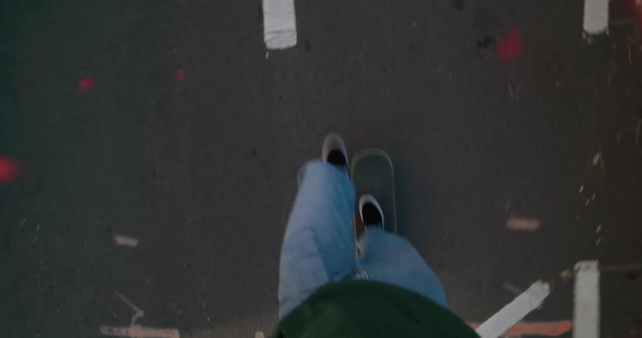 A man rides his skateboard on a city street