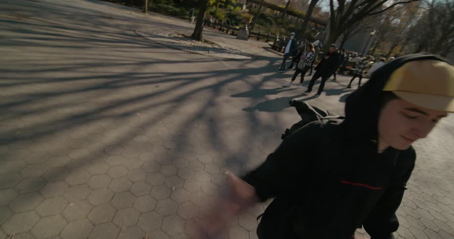 Point of view footage of a friend performing a handshake on a park in the city
