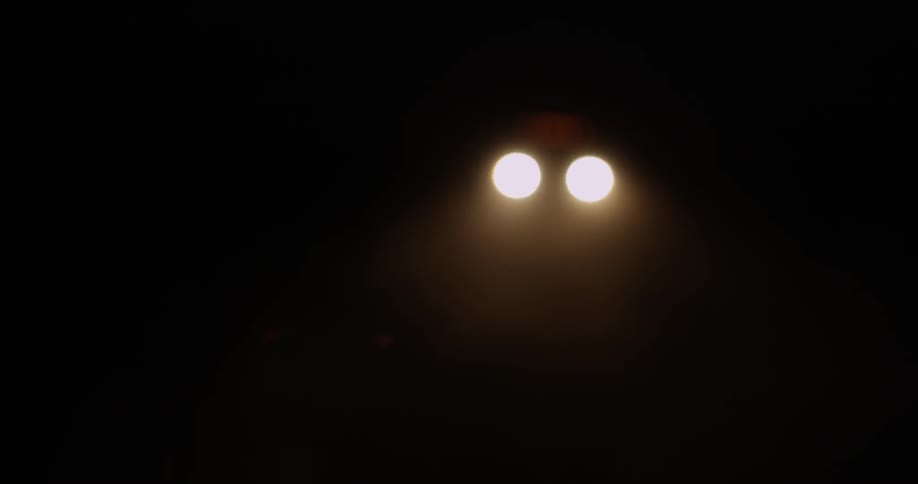 Headlights on a car in the dark night