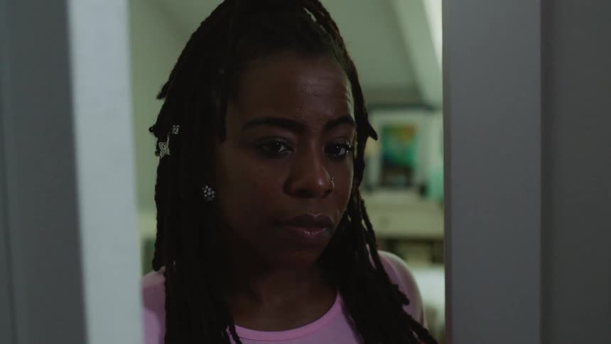Woman opens door and looks through doorway