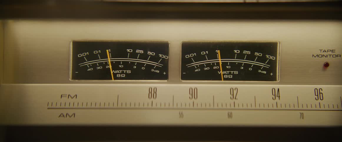 Close up of the moving dials of a vintage stereo system