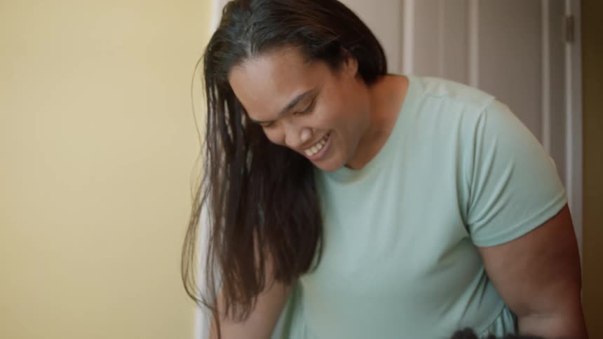 A woman is talking to someone in the room
