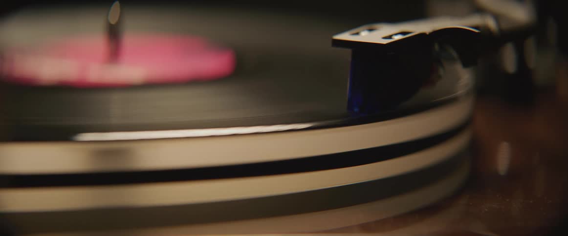 Vinyl record rotates on record player turntable