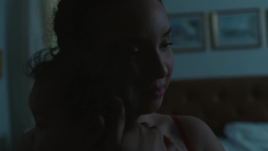 A mother is holding her newborn indoors