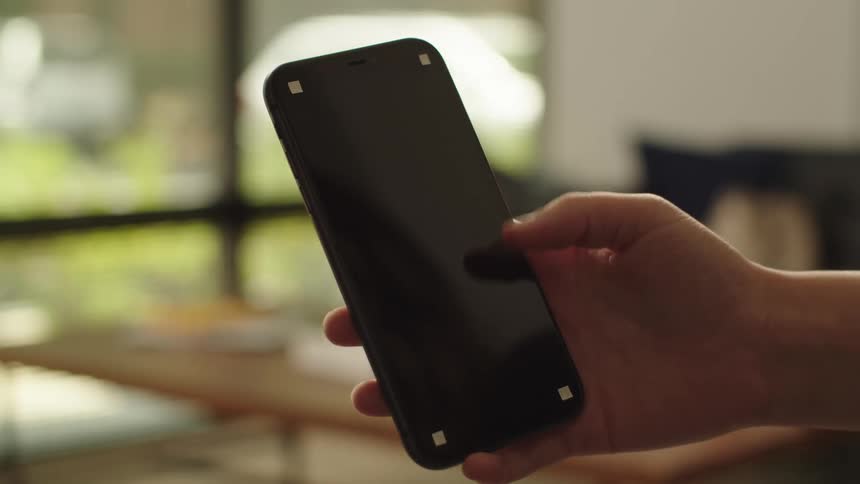 A hand is holding a cell phone