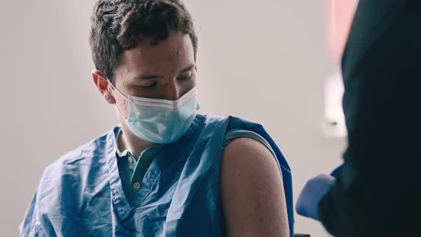 Nurse administers a shot to a patient