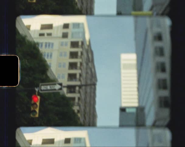 Traffic light hanging near one way sign downtown is red