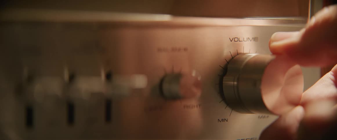 Person turns volume on stereo up