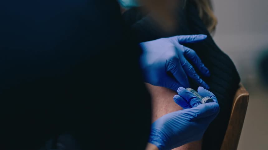 Nurse injects vaccination