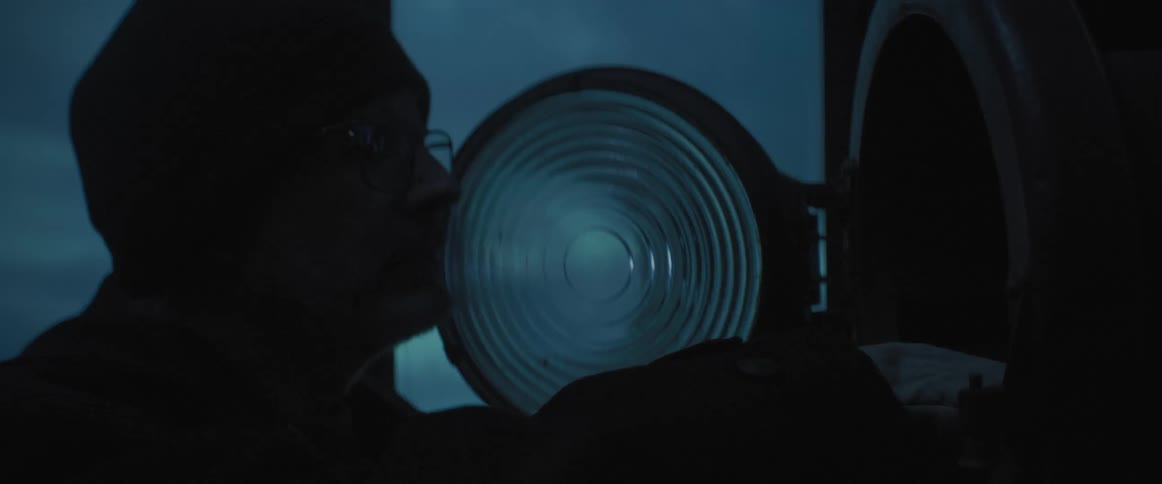A man replaces a bulb inside a beacon closing the lamp cover before leaving