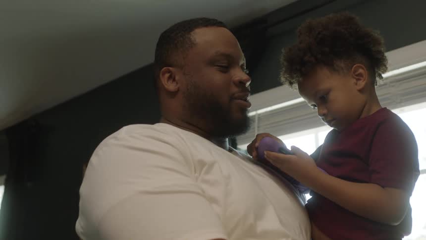 A father kisses his son on the forehead