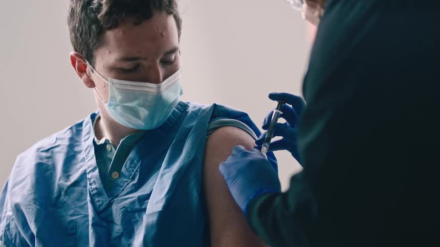 Nurse uses syringe to give patient an injection