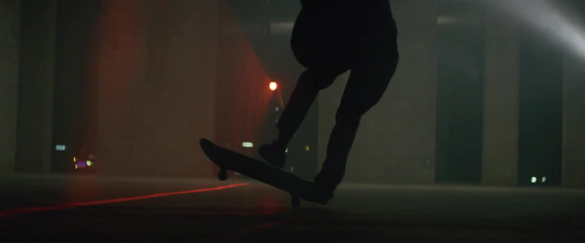 Skateboarder has to regain balance after failing skateboard trick at night