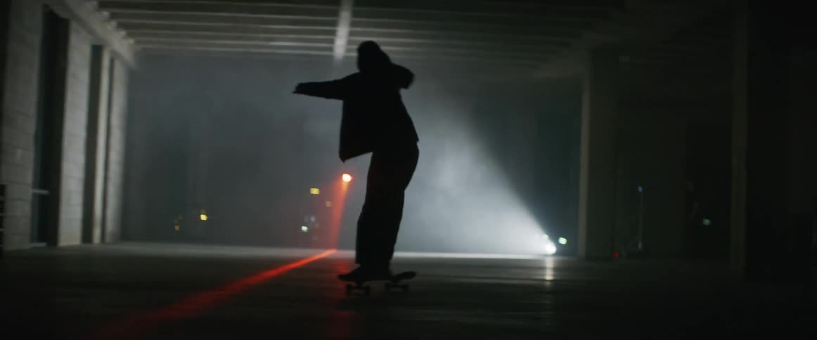 A person sways back and forth racing on the skateboard