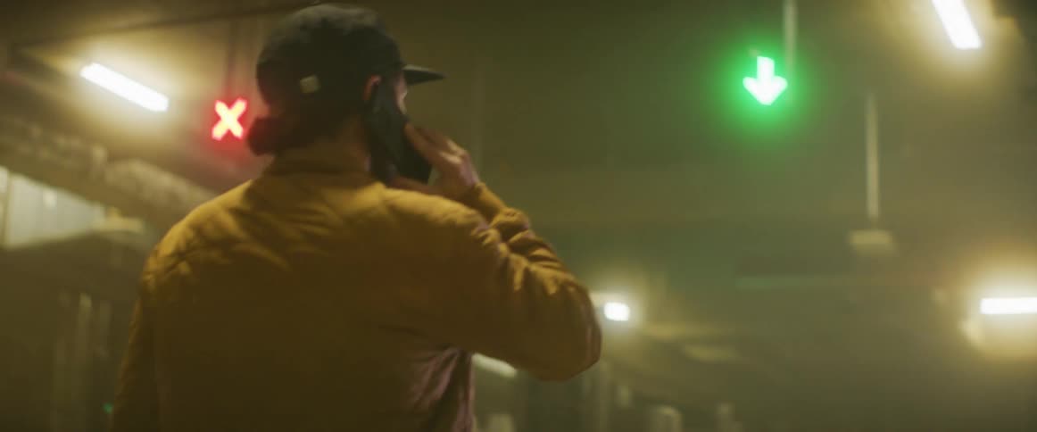 A man is talking on his cell phone while searching around the building
