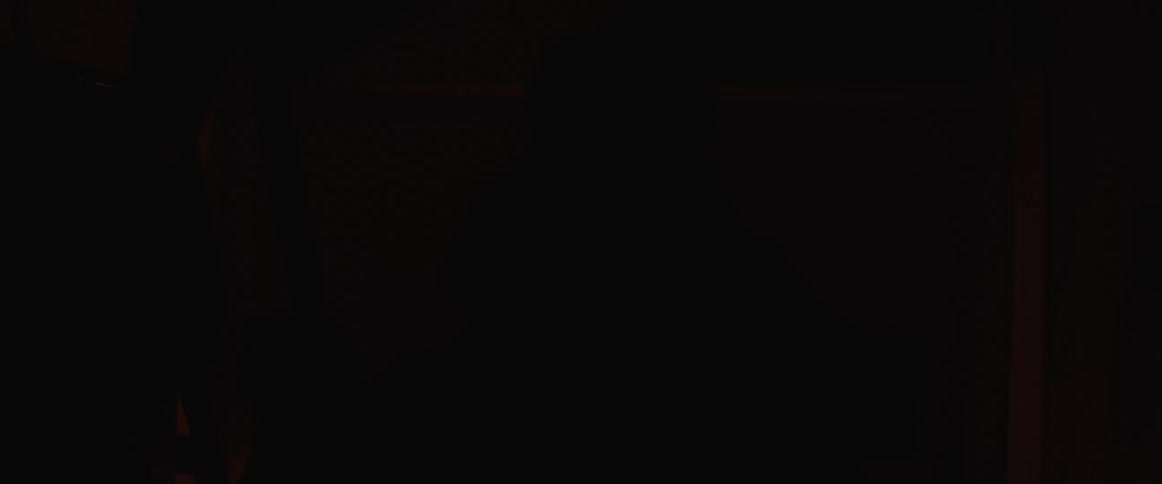 A couple dance in the dark room with flashing lights
