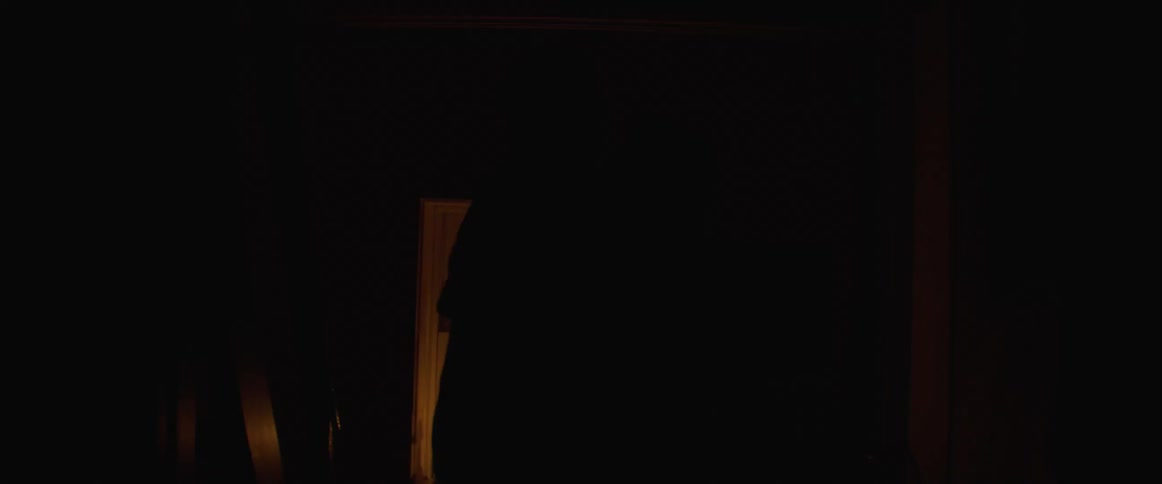 Husband and wife romantically dancing around inside the house with candle light