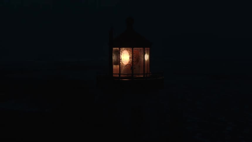 The lighthouse is flashing a light at night