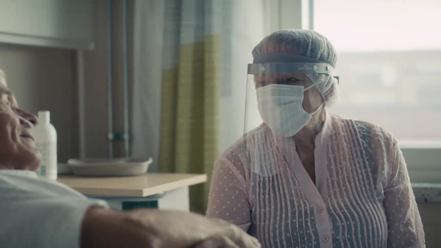 A patient has a visitor in his hospital room