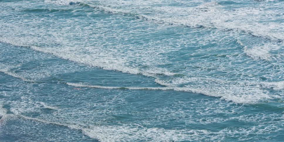 The waves crash against the shore