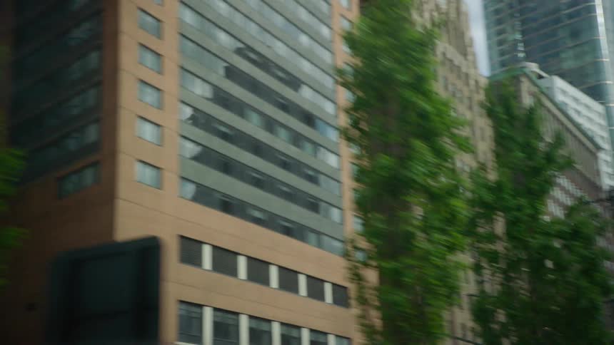 Vehicle travels along street through downtown