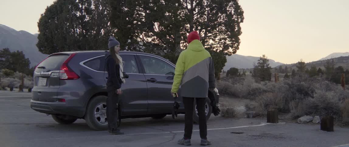 Man and Woman Talking in a Parking Lot With Warm Friendly Conversation and Connection.
