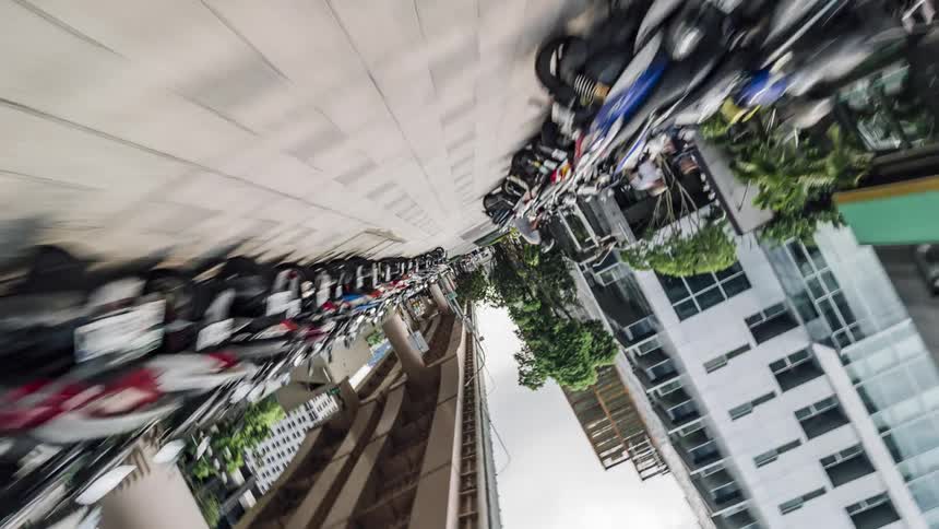 Pedestrians move along walkway near overpass in downtown
