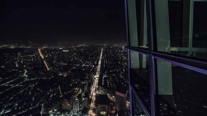 Time lapse view of an urban city at night is displayed