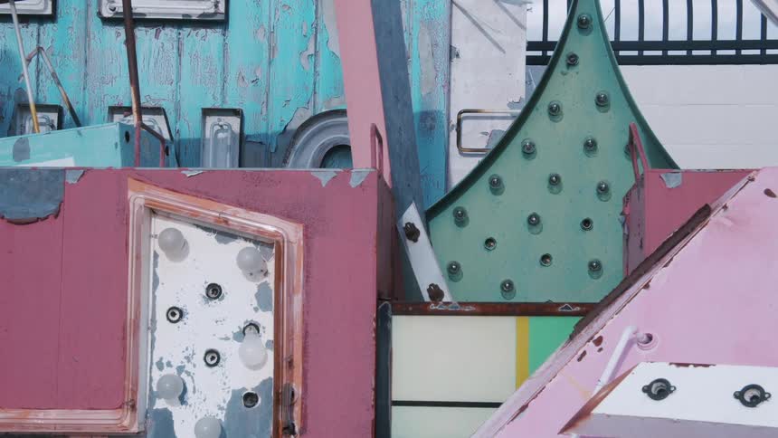 A buildings walls and roof are painted in color pastels and art